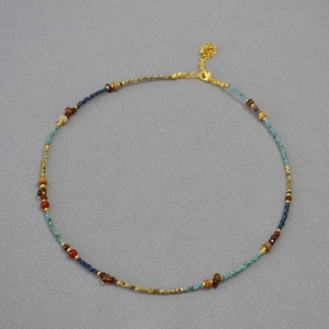 Detail of beaded necklace with turquoise, lapis beads and gold lobster clasp extension