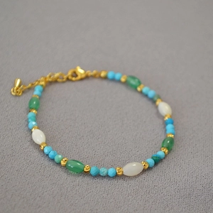 Detail of bohemian turquoise and agate beaded bracelet with adjustable gold chain