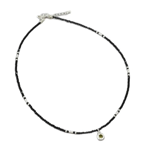 Elegant beaded necklace with black spinel, silver accents and a green stone pendant