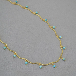Vintage style gold-plated brass necklace featuring faceted turquoise beads on a thin chain
