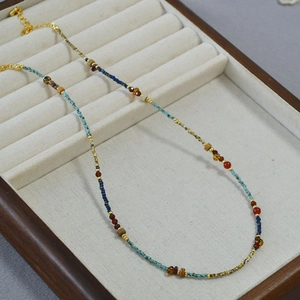 French vintage style beaded necklace with turquoise and red agate beads on velvet tray