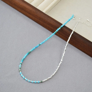 Detail view of turquoise and silver faceted bead necklace with adjustable lobster clasp