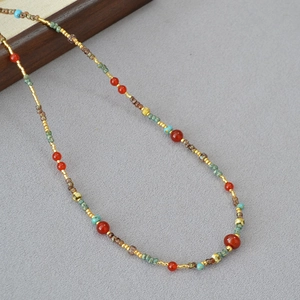 Detail of red agate and turquoise beaded necklace with retro Dunhuang style design