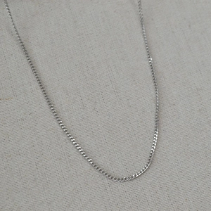 Minimalist silver stainless steel curb chain necklace with a polished modern finish