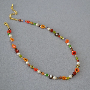 Détail d'un collier de fleurs fait main bohème avec des perles Miyuki colorées et pierres