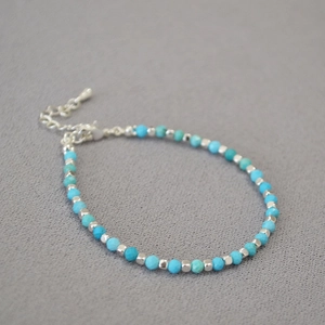 Close-up of turquoise beaded bracelet with silver metal accents and adjustable clasp