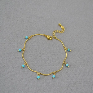 Detail of gold brass chain with turquoise beads, lobster clasp and extender