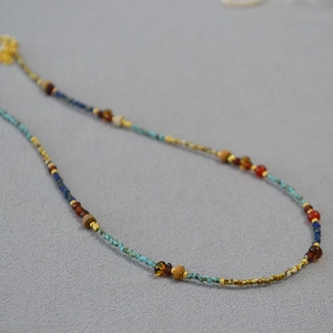 Close-up of vintage multi-colored beads necklace with turquoise and agate stones