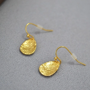 Detail showing the hammered texture of gold plated leaf shaped teardrop earrings