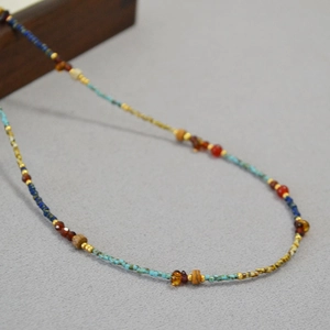Detailed macro shot of vintage turquoise and red agate beaded necklace with metal spacers