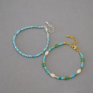 Detail of turquoise beaded bracelets featuring diverse colorful stones and lobster clasp