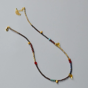 Detail of vintage beaded necklace with yellow teardrop beads and gold lobster clasp