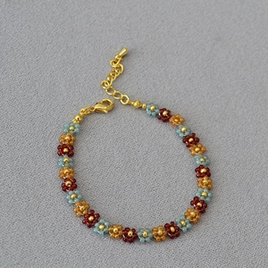 Handmade bohemian beaded flower bracelet with sunset colors and gold-plated clasp