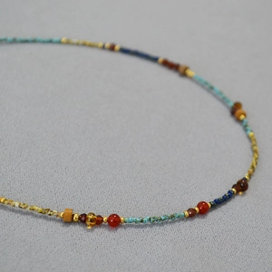 Macro shot of French vintage beaded necklace with turquoise and red agate seed beads