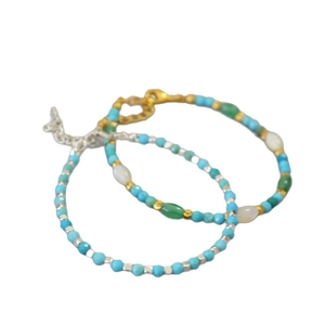 Minimalist turquoise beaded bracelets with gold and silver extension chains on white