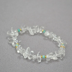Macro detail of irregular white crystal beads and turquoise accents on beaded necklace
