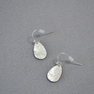 Handcrafted silver leaf-shaped drop earrings with hammered texture and hook design