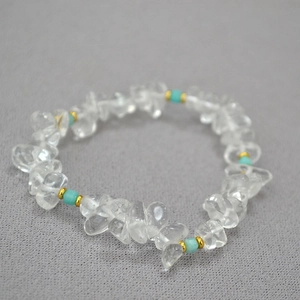 Close-up of beaded necklace with irregular clear crystals and light blue amazonite stones