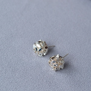 Faceted silver hollow ball stud earrings featuring a geometric multi-surface 3D design