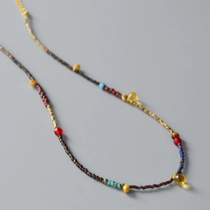 Detailed macro view of retro handmade bead necklace with yellow teardrop pendants