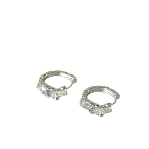 Textured silver huggie earrings with clear crystals and organic molten metal design