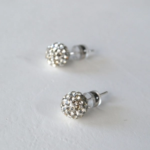 Macro shot of sparkling crystal clay ball stud earrings with 925 silver needle for women