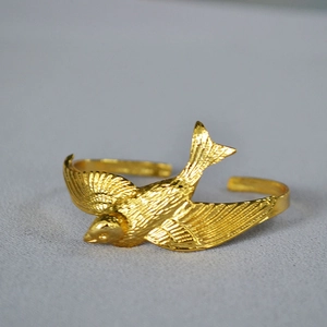 Detailed close-up of 18k gold plated brass swallow bird open adjustable ring