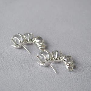 Detailed view of C-shaped earrings with gradient transparent glass beads and silver claws
