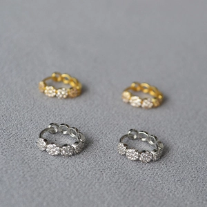 Detail of gold and silver micro-pave cubic zirconia hollow round hoop earrings