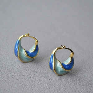 Artistic spiral earrings with blue enamel gradient and 18K gold plated metal texture