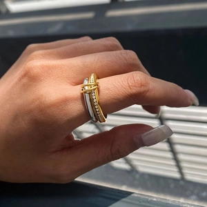 Close-up of multi-layered linked ring with cubic zirconia on a woman's hand