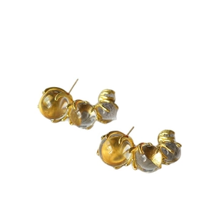 Golden C-shape earrings with gradient ice-clear glass beads in a minimalist luxury design