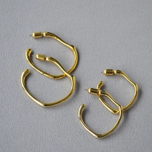 Detailed top view of gold minimalist irregular wavy hoop earrings in two sizes