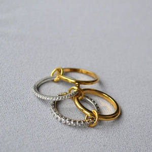 Macro shot of interlocking four-piece ring set with gold bands and silver diamond pave rings
