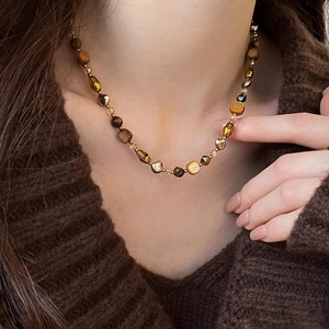 Vintage Maillard tiger eye beaded necklace worn on a brown knit sweater neck