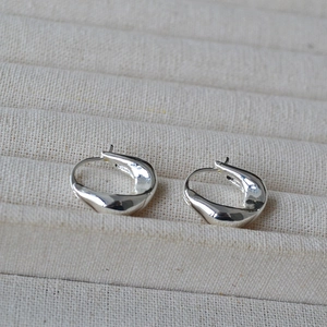 Minimalist silver irregular U-shaped hoop earrings with polished twisted metal design