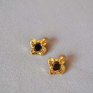Gold plated wrinkled flower earrings with black zircon center in a 45-degree angled view