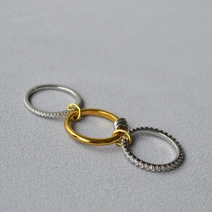 Modern gold and silver interlocking rings set with sparkling pave-set diamonds