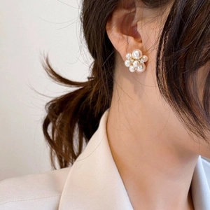 Boucles d'oreilles élégantes en perles et argent 925 portées par un mannequin