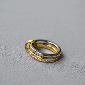Detail of interlocking triple rings with silver gold plating and pave crystal accents