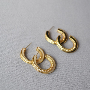 Detailed view of Mobius earrings with black and white enamel and pave zircon crystals