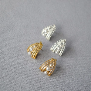 Detailed macro of vintage lace-style earrings with sparkling diamonds and pearls
