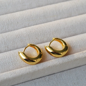 Minimalist asymmetrical gold plated hoop earrings with a polished mirror finish for women