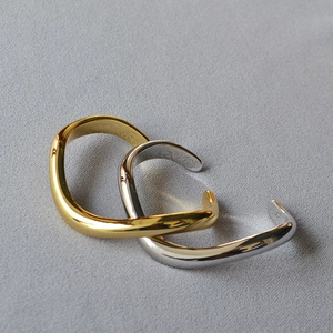 Minimalist irregular wavy cuff bracelets in gold and silver finish with high mirror polish