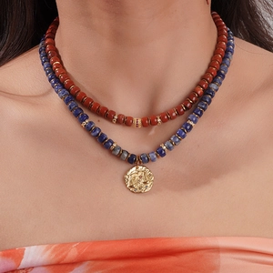 Detail of double-layer beaded Libra zodiac necklace with natural stone and 18K gold pendant