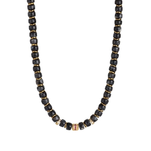 Detailed macro view of 18K gold plated bead necklace with natural stones and red gemstone