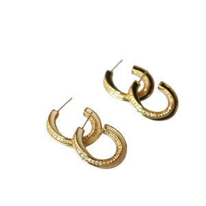 Gold plated Mobius loop earrings with black and white enamel and sparkling zircons