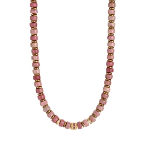 Macro view of pink natural stone necklace with gold spacers and red crystal bead detail