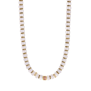 Detail of beaded necklace with frosted white cubes and gold spacers with luxury crystal charms