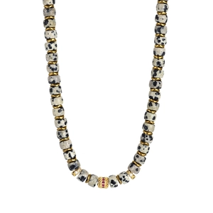 Macro view of 18K gold Dalmatian Jasper beaded necklace with red gemstone pendant detail